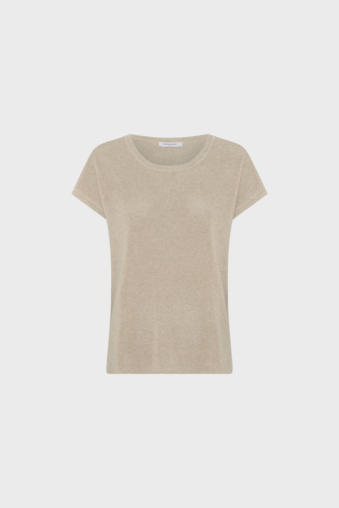 A plain, beige short-sleeve knit top with a round neckline is displayed on a white background. The shirt has a simple, casual design and a relaxed fit.