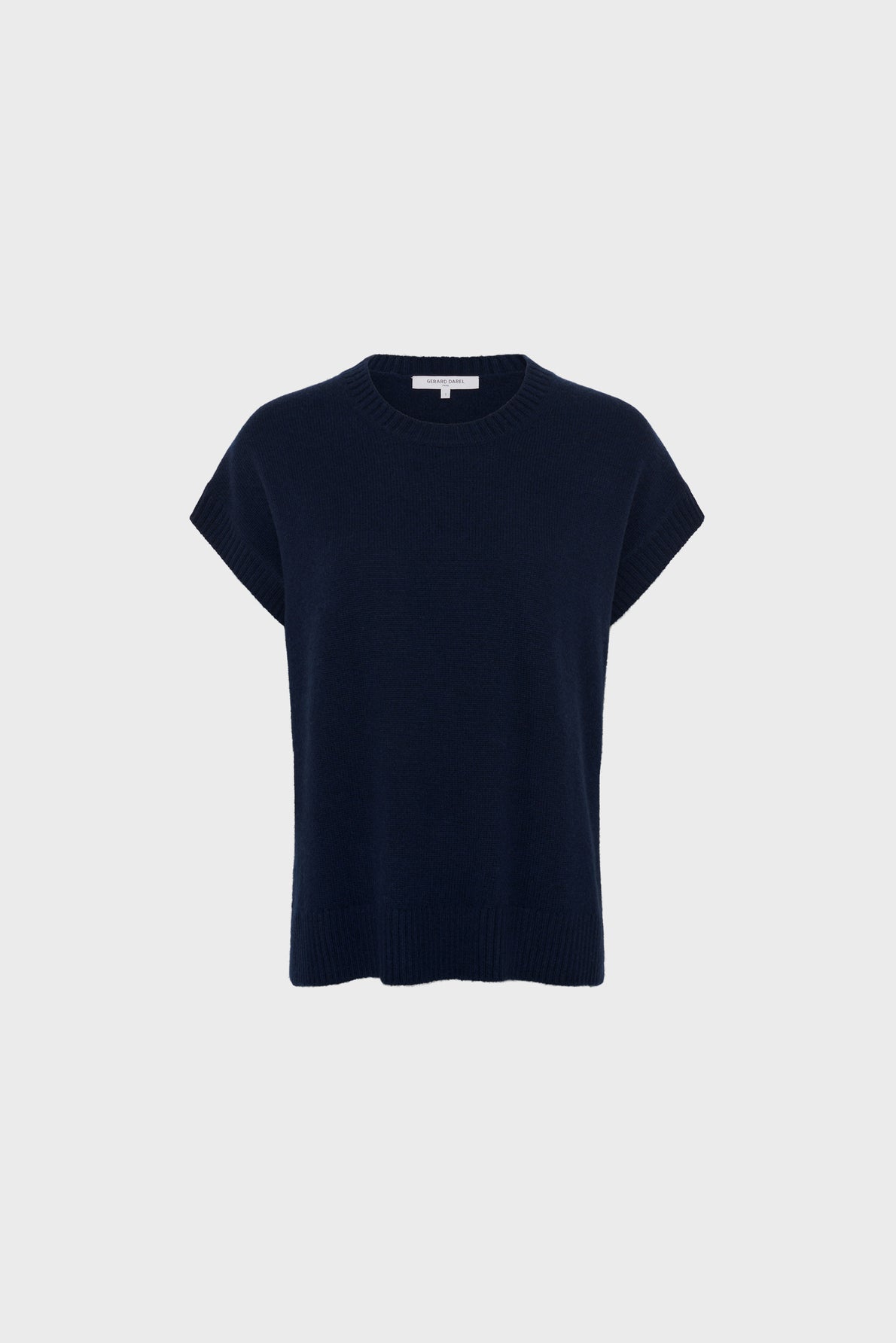 A plain, navy blue (“bleu marine”) short-sleeved knit sweater with a crew neckline and ribbed edges, displayed against a light gray background. This versatile pull cachemire femme offers timeless style and elegance for any occasion.