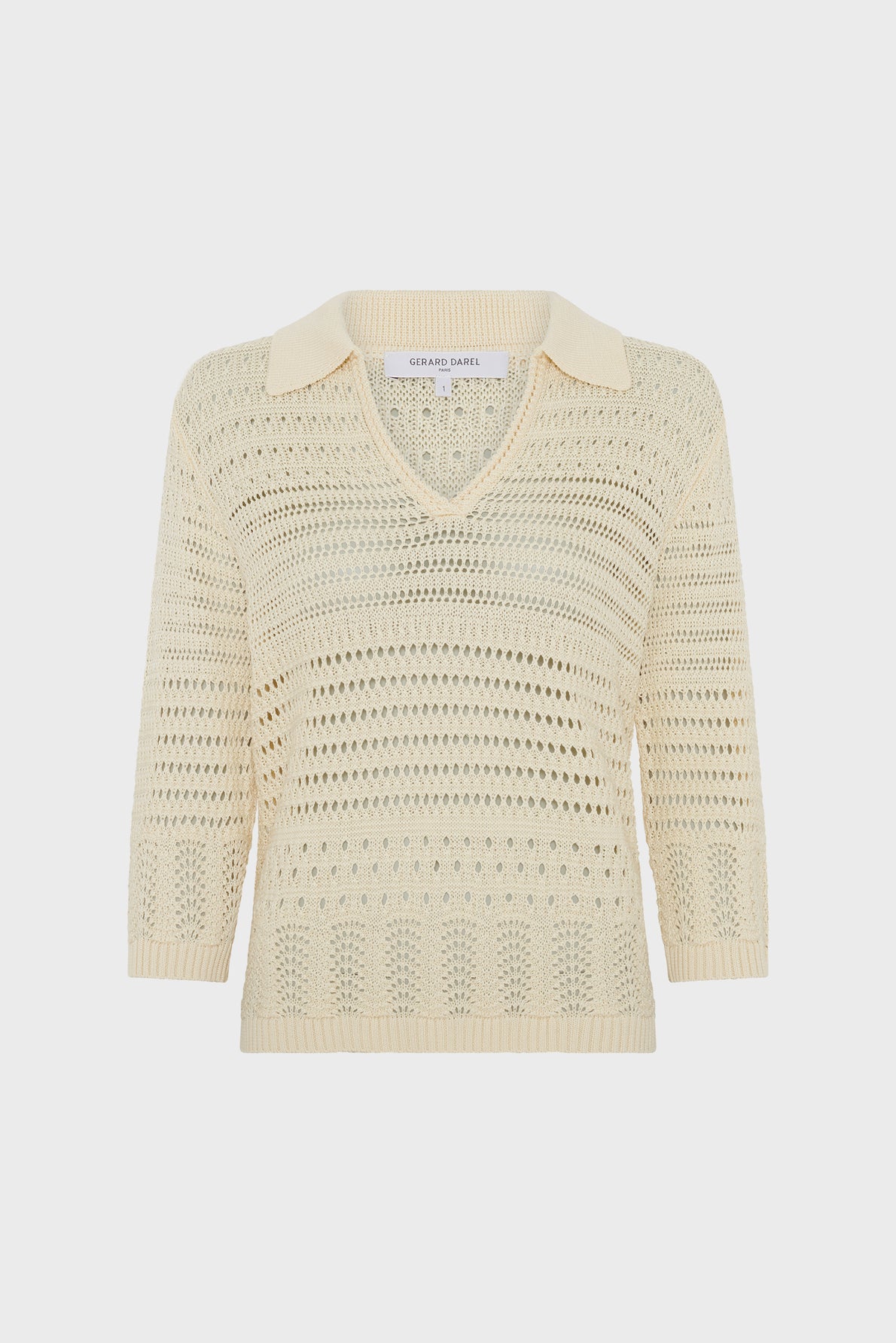 Cream-colored polo en crochet, knit sweater with a V-neck and collar, featuring a loose maille ajourée openwork pattern and three-quarter length sleeves, displayed on a plain white background.