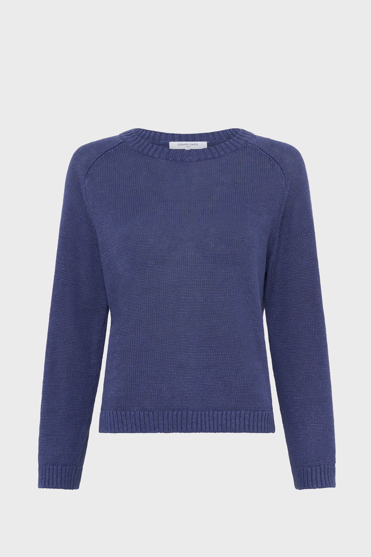 A plain, long-sleeved pull col rond in navy blue knit with a round neckline and ribbed cuffs and hem, displayed on a white background.