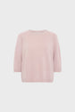 Light pink, short-sleeved knit pull femme in soft cachemire with a crew neckline and ribbed hem and cuffs, displayed against a plain white background.