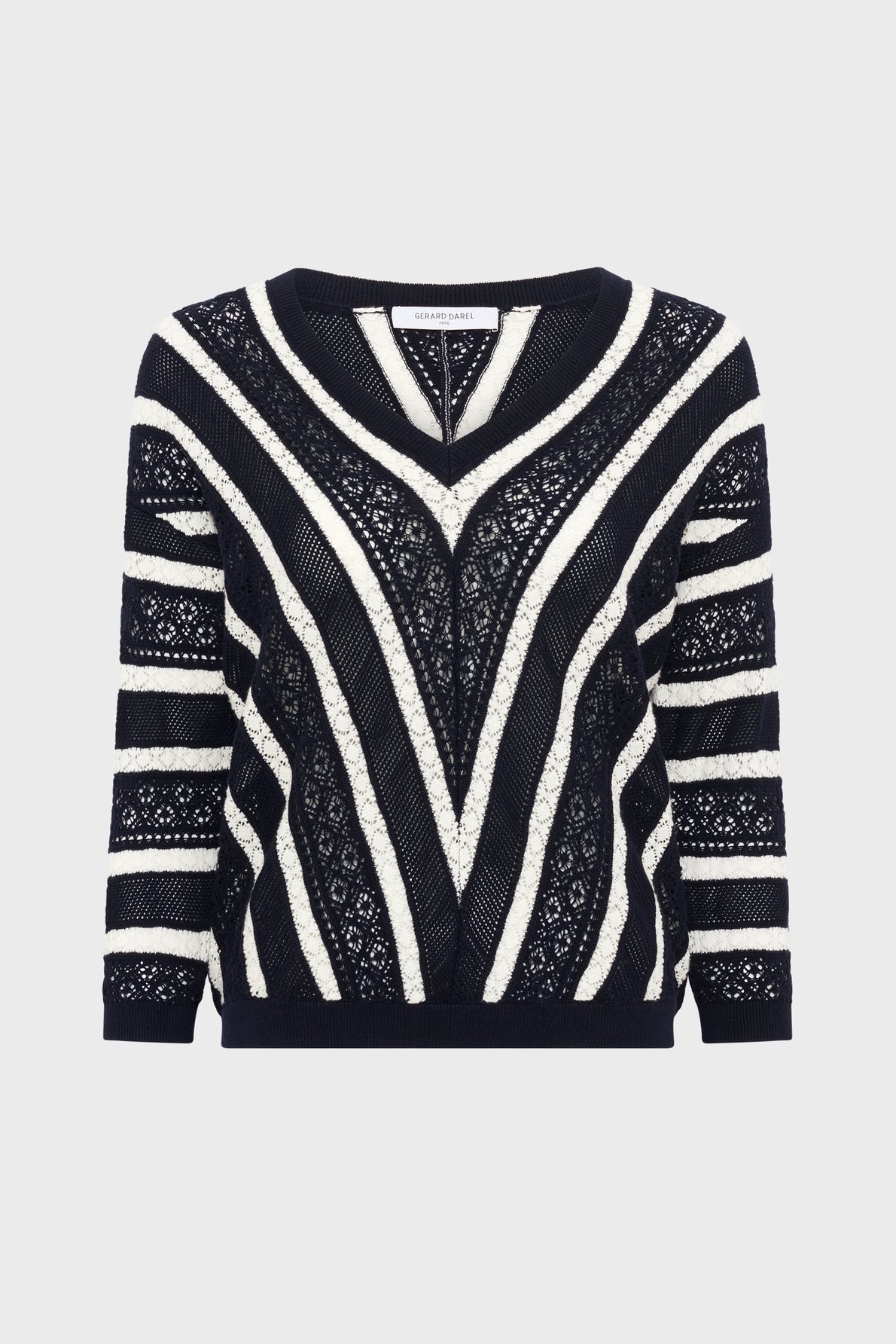 Black and white long-sleeve pull rayé sweater crafted from soft coton, featuring maille ajourée lace and solid knit stripes forming a V pattern on the front and horizontal stripes on the sleeves, displayed on a plain white background.