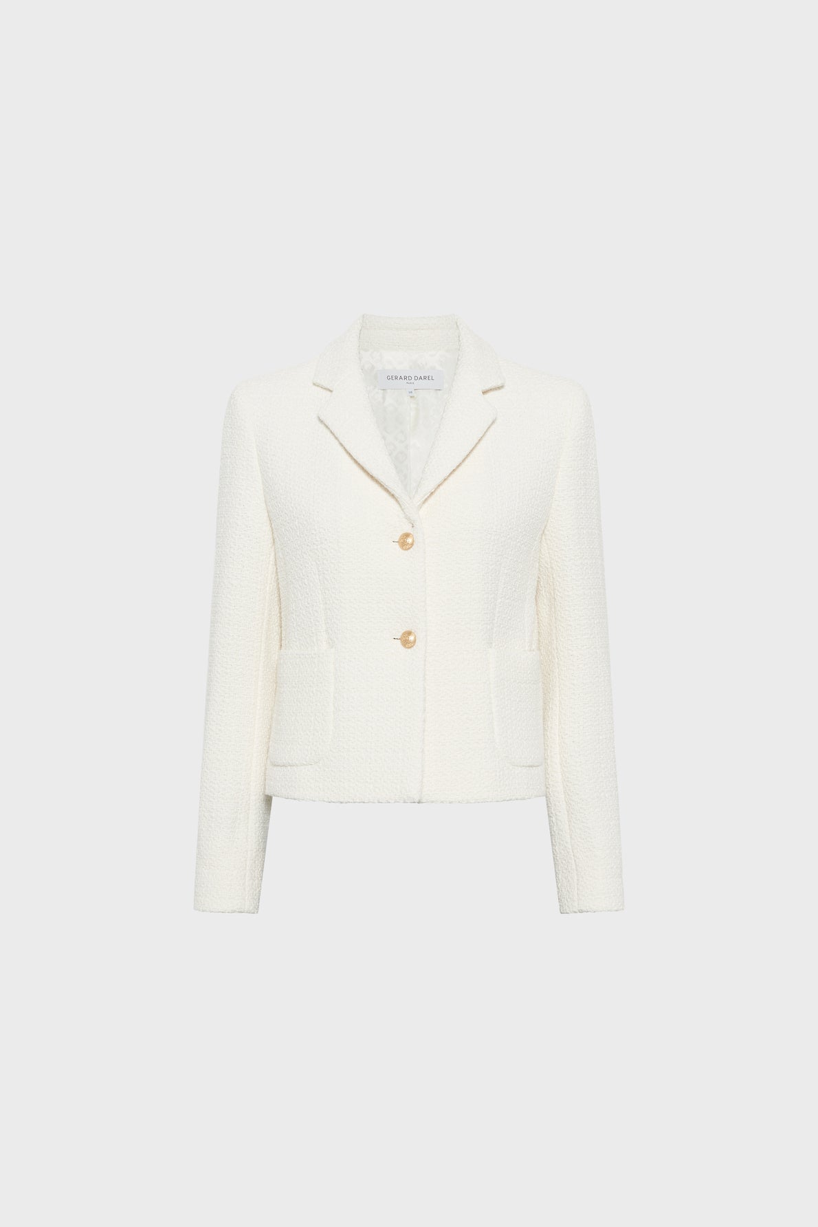 Cream-colored, textured womens blazer with long sleeves, two front pockets, a notched collar, and two gold buttons, displayed against a plain light gray background.