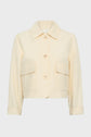 Cream-colored, long-sleeve, button-up veste courte with a collar and two large front pockets, displayed on a plain white background.