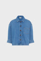 Cropped denim jacket with long sleeves, a front chest pocket, button closure, and a classic collar, displayed on a white background.