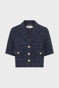 Navy blue short-sleeve cropped jacket with a plaid pattern, gold buttons, two front flap pockets, and a notched collar.