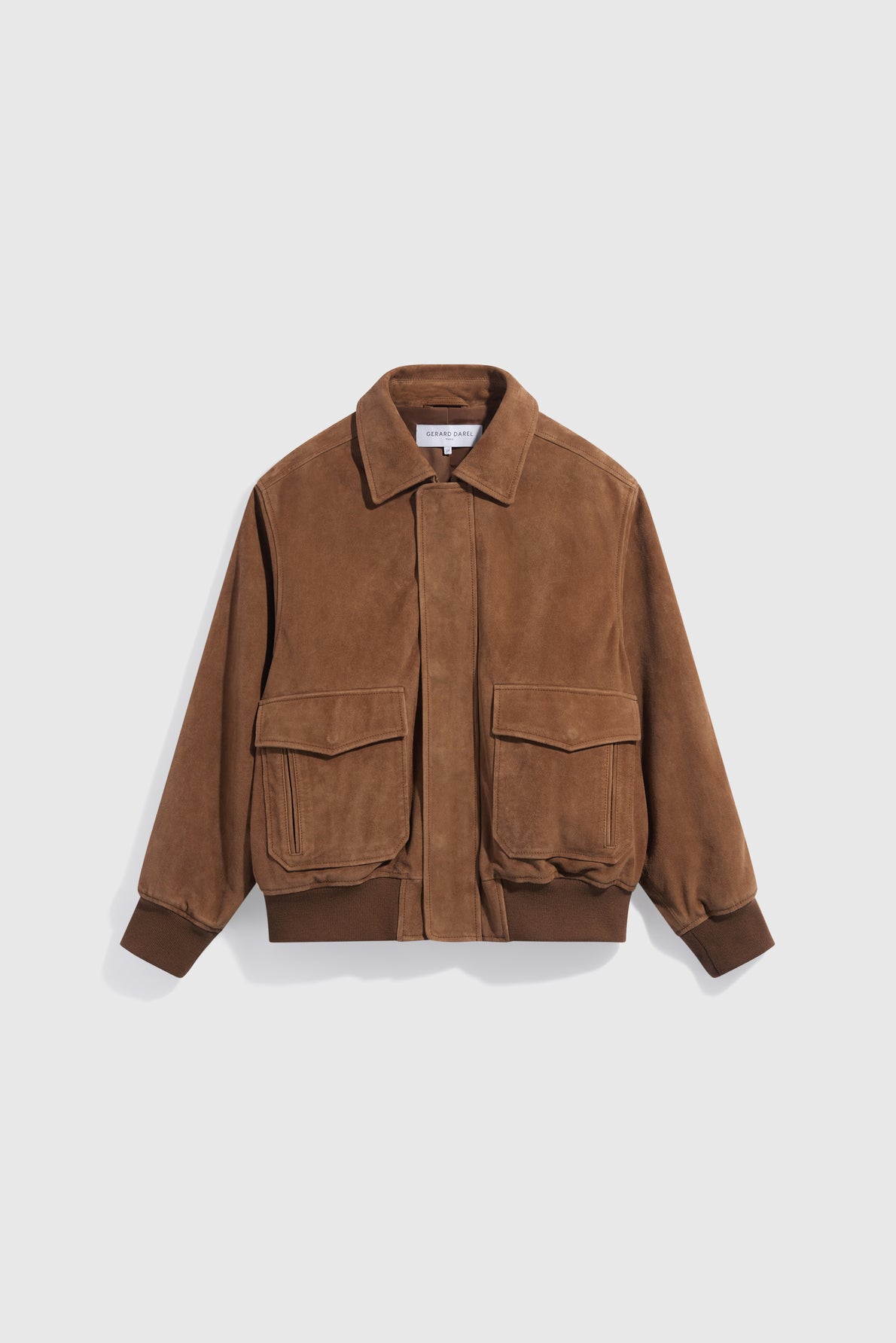 Brown suede bomber jacket with a collar, front zipper, two large front flap pockets, and ribbed cuffs and hem, displayed on a plain white background—a classic blouson cuir velours homme in an elegant taupe shade that effortlessly blends sophistication with casual style.