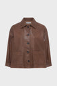 A brown leather jacket with a collar, front button closure, two large front pockets, and long sleeves, displayed against a plain white background.