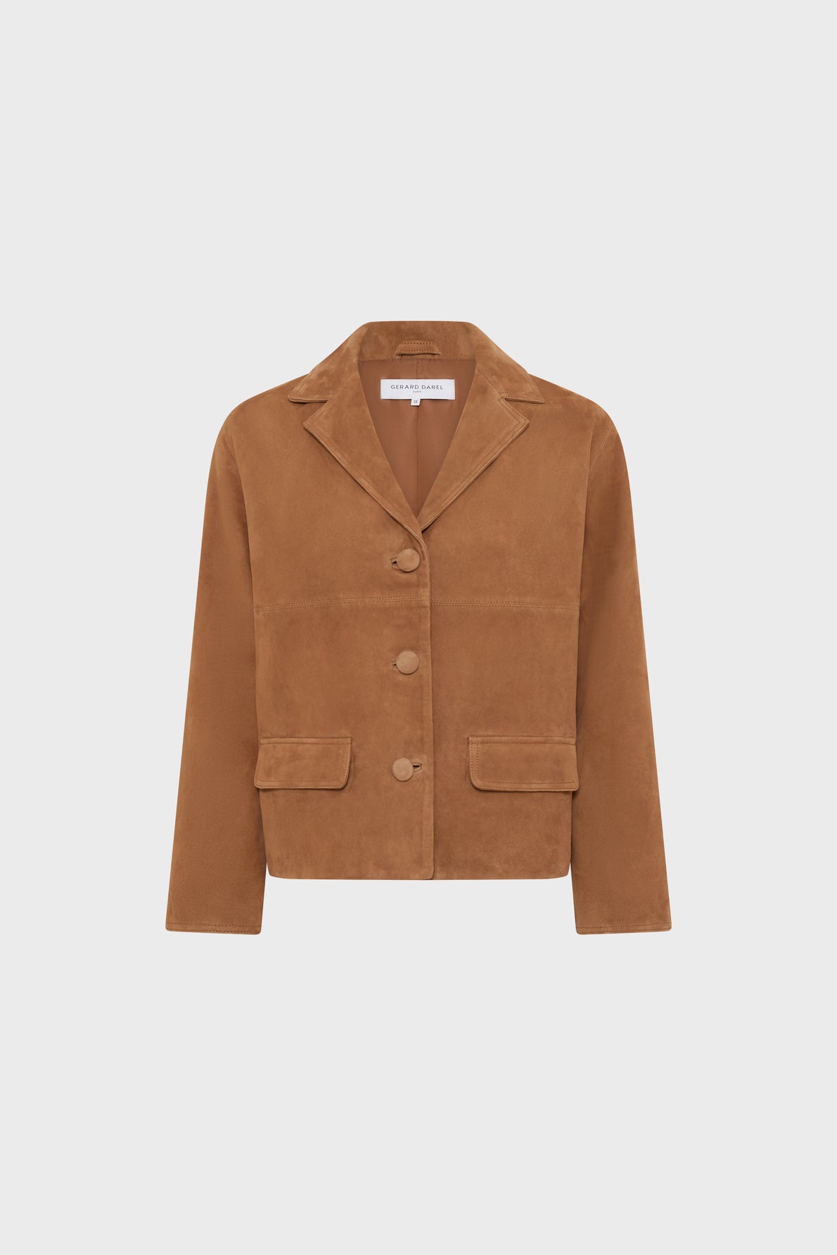 Brown suede jacket with a notched collar, three front buttons, long sleeves, and two front flap pockets. The jacket has a boxy, tailored fit and is displayed against a plain white background.