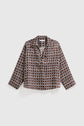 A long-sleeve blouse Lorra with a brown and white imprimé graphique diamond pattern, featuring a collar and a V-neck, laid flat on a white background.
