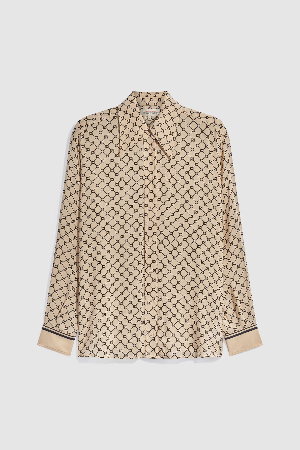 Beige long-sleeve button-up chemise fluide with a repeating black geometric motif imprimé and black trim on the cuffs, displayed on a plain white background.