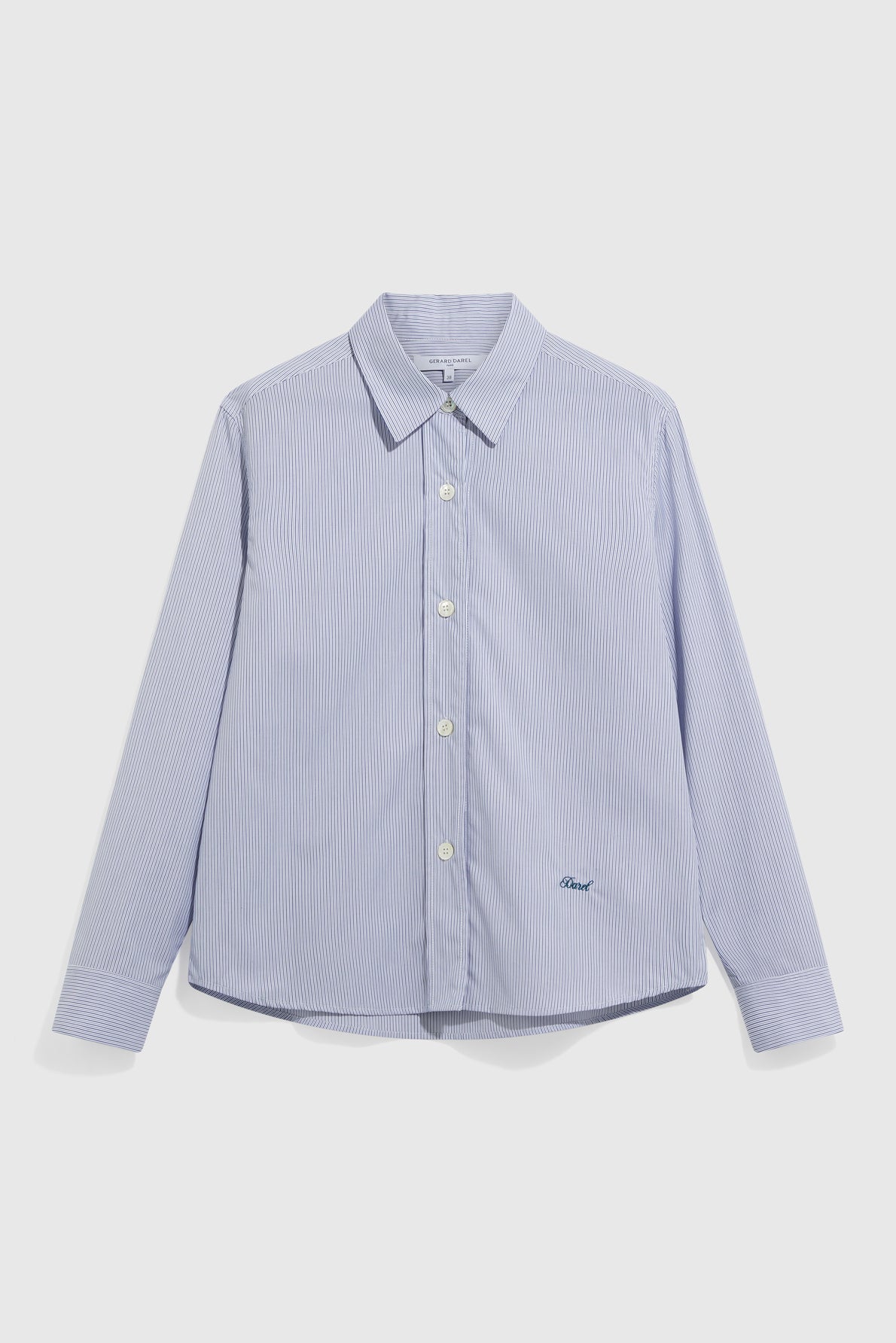 Light blue and white pinstripe button-up shirt with long sleeves and a collar, displayed against a plain white background. This classic chemise rayée, crafted from soft cotton, features a small embroidered logo near the hem.