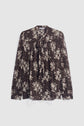 Dark brown long-sleeve chemise en mousseline with a light imprimé floral, featuring pleated sleeves and finished with an elegant col lavallière bow tie at the collar, displayed against a white background.