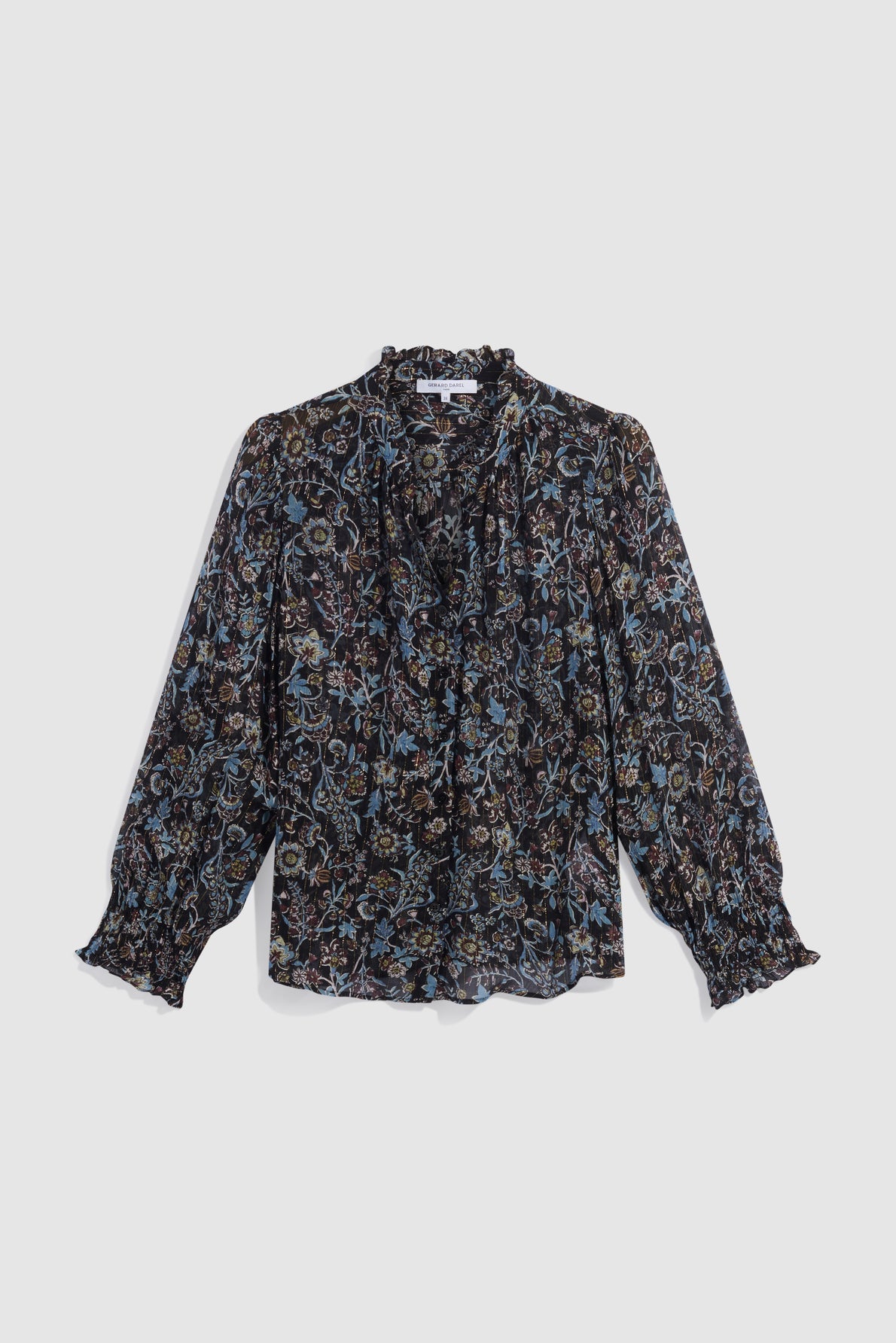 Long-sleeve chemise à fleurs with a col volanté and cuffs, featuring a dark floral pattern in blue, brown, and beige tones. Crafted from mousseline soie for a delicate finish, this blouse has a loose fit and is displayed on a plain, light background.