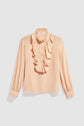 A peach-colored, long-sleeve blouse femme with a ruffled col volanté and front, button-down closure, and buttoned cuffs, displayed against a plain gray background.