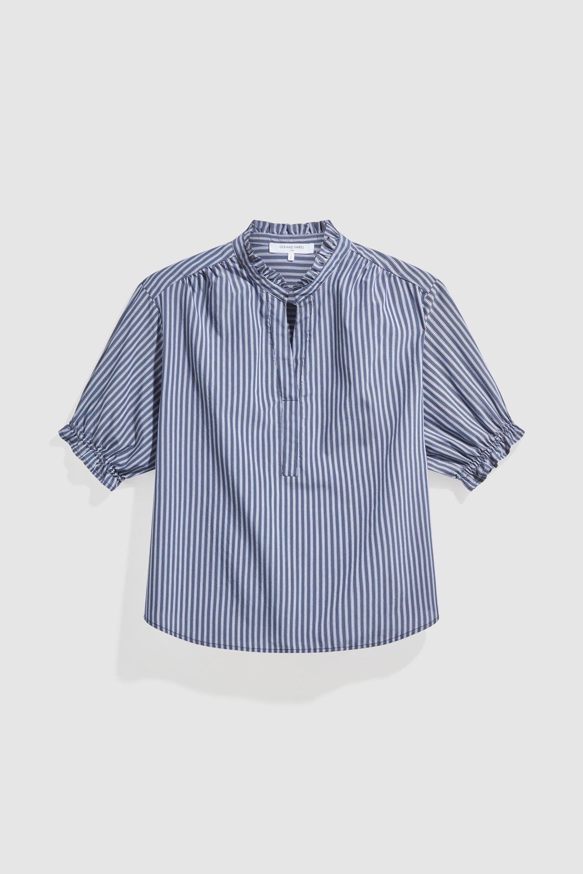 Blue and white vertically striped short-sleeve blouse (blouse rayée) with a col montant à volants, partial button placket, and ruffled cuffs, displayed on a plain white background.