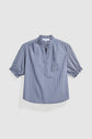Blue and white vertically striped short-sleeve blouse (blouse rayée) with a col montant à volants, partial button placket, and ruffled cuffs, displayed on a plain white background.