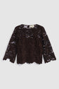 A long-sleeve, dark brown top dentelle blouse with a round neckline and scalloped edges, featuring an elegant motif fleuri design, laid flat on a light gray background.