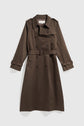 Long dark brown trench coat with a belt, double-breasted buttons, epaulets on the shoulders, and adjustable straps on the sleeves, this élégant manteau femme is displayed on a light background.