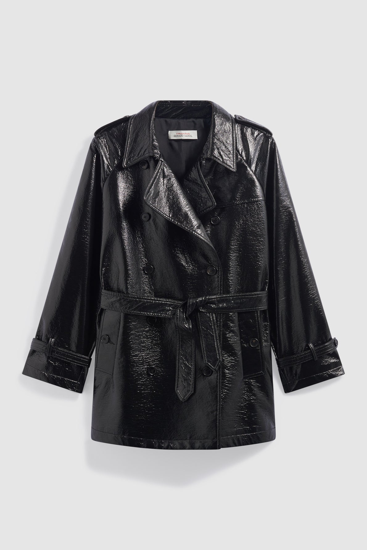Shiny black vernis craquelé noir faux leather trench coat with a belted waist, double-breasted button closure, wide lapels, and long sleeves, displayed against a plain light background.