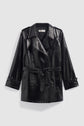 Shiny black vernis craquelé noir faux leather trench coat with a belted waist, double-breasted button closure, wide lapels, and long sleeves, displayed against a plain light background.