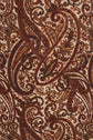 Close-up of a fabric featuring an intricate imprimé cachemire pattern in shades of brown, burgundy, and black on a cream background, with swirling floral and leaf motifs.