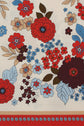 A motif floral pattern with red, blue, and beige flowers and green leaves on a white background. There is a red and blue floral border along the bottom edge, adding a charming carré rétro touch.
