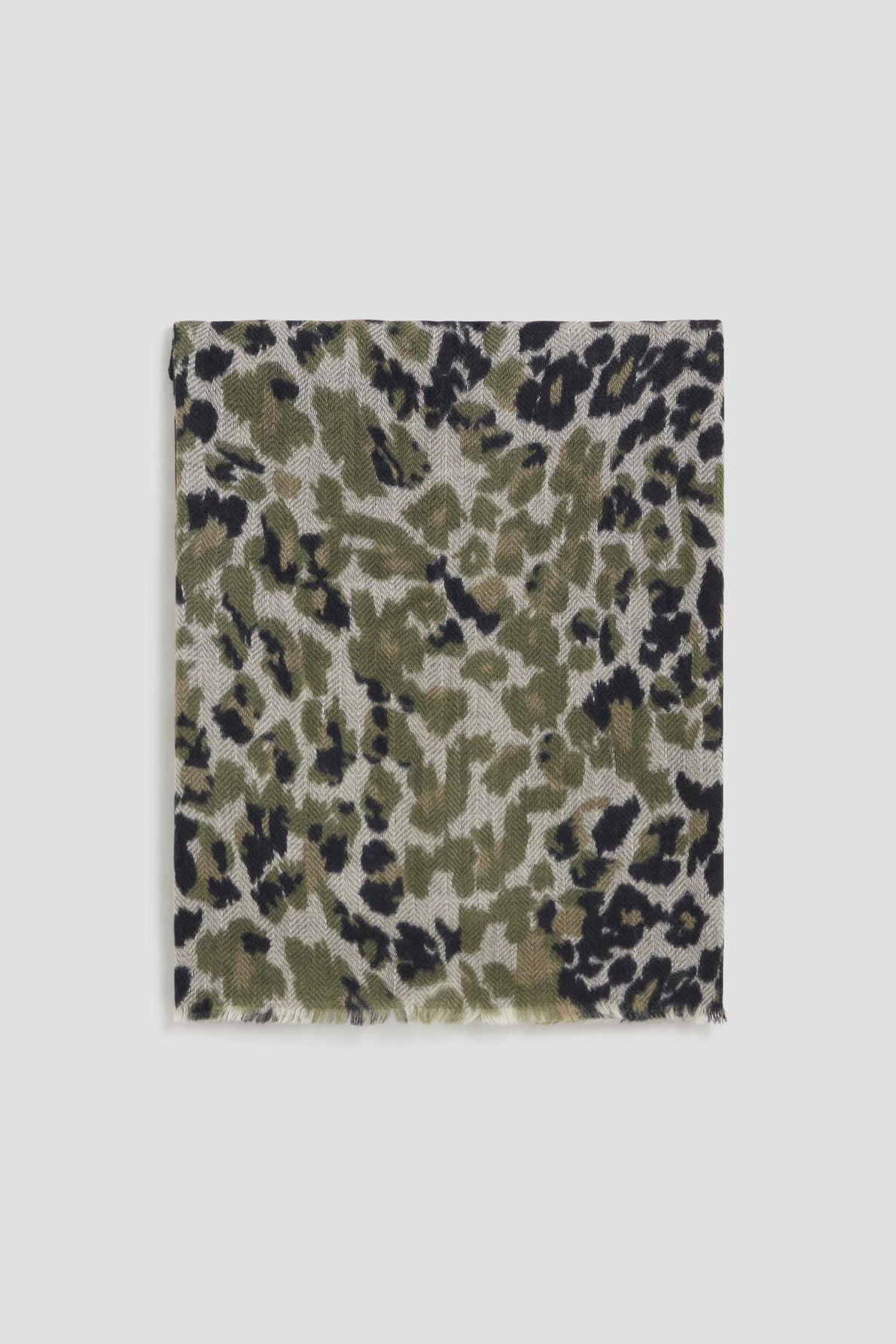 A square scarf with a green, black, and beige animal print pattern reminiscent of an écharpe léopard, featuring slightly frayed edges, displayed on a plain white background.