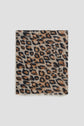 A square scarf with an imprimé léopard pattern in shades of brown, black, and beige, displayed flat against a plain light background.