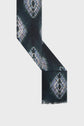 A black écharpe tie and dye with white and light blue diamond patterns, arranged in an L shape on a plain light background.