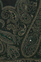 Close-up of dark green imprimé cachemire fabric with embroidered details and small green sequins, creating an intricate and textured decorative design reminiscent of traditional motifs indiens.