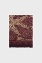 A folded beige and maroon paisley-patterned écharpe cachemire with a decorative border and fringed edge is shown against a plain white background.