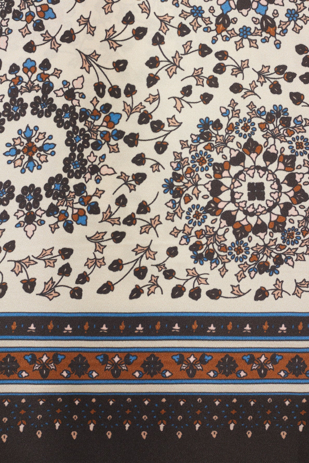 A detailed fabric pattern with motif floral and leafy motifs in black, brown, and blue on a cream background evokes a subtle foulard bohème charm. Border designs run along the bottom in matching colors, reminiscent of an elegant carré en soie.