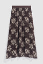 A brown, ankle-length jupe en mousseline with a black waistband and a white floral print pattern, displayed flat on a white background.