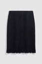 A black textured pencil skirt, reminiscent of a classic jupe tweed, with a straight fit and fringe detail along the bottom hem, displayed against a plain light gray background.