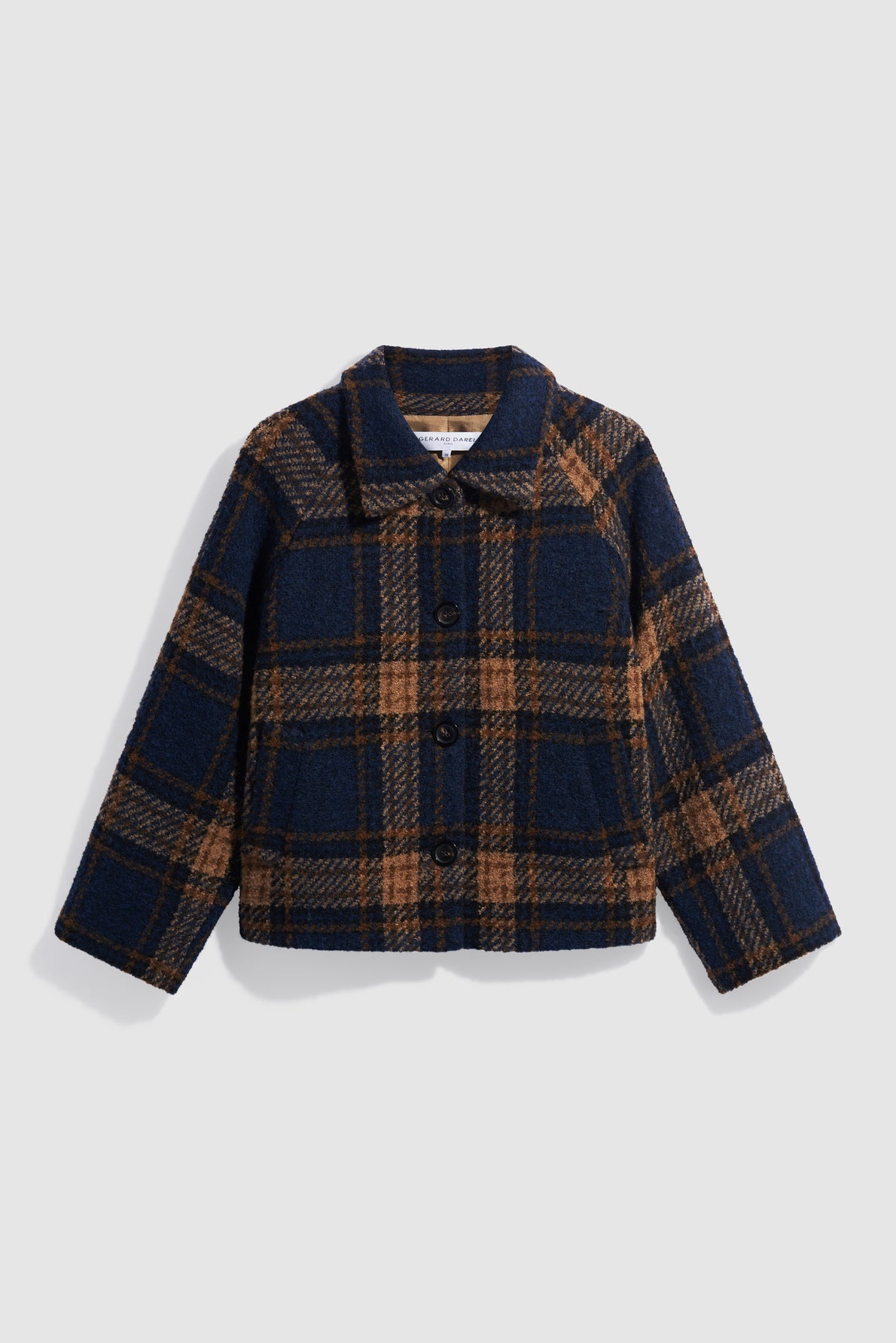 A navy blue and brown plaid wool jacket with long sleeves, collar, three buttons down the front, and a boxy fit is displayed on a plain white background. This manteau à carreaux offers a stylish and timeless look, perfect for layering during cooler weather.