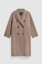 A long, light brown manteau double boutonnage in wool with black buttons, two front pockets, and a notched lapel, displayed against a plain white background.