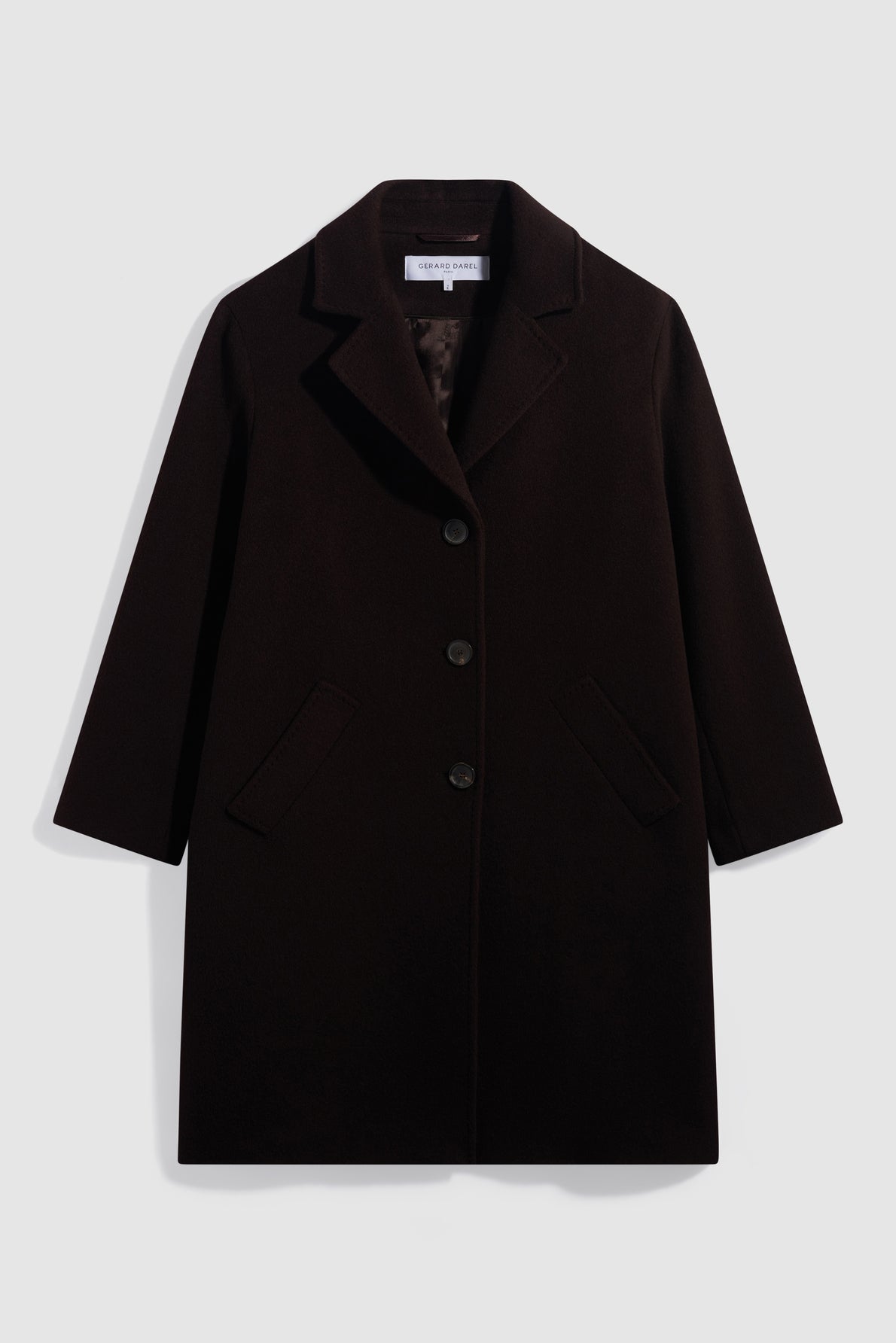 A black, knee-length manteau femme in laine angora with three buttons, two angled front pockets, and a notched lapel collar, displayed flat against a white background.