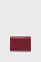A small, rectangular maroon leather wallet with visible stitching, displayed upright against a plain white background. This portefeuille XS femme is crafted for elegance and practicality, making it the ideal petit portefeuille cuir for those who appreciate minimalist style.