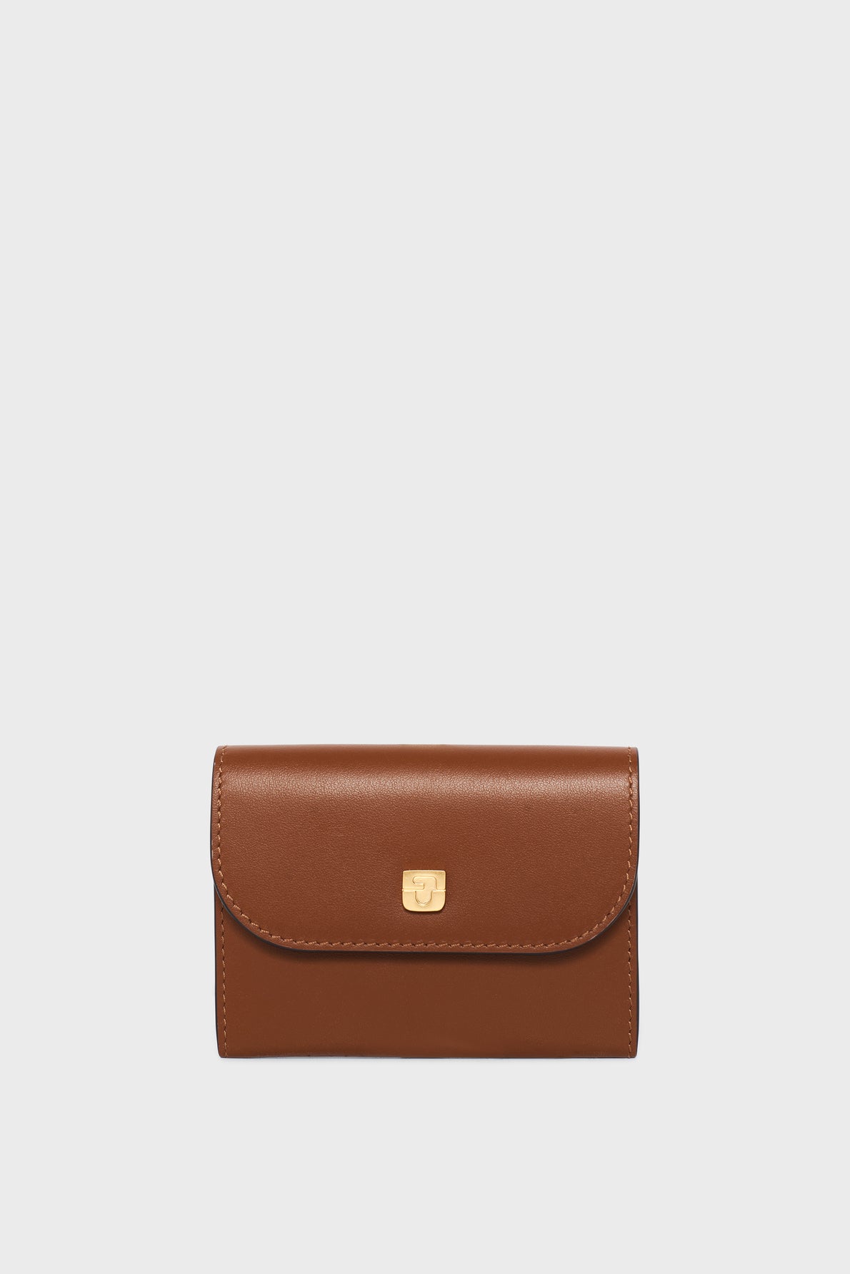A brown leather wallet with a curved flap, gold clasp, and visible stitching, displayed against a plain white background—this petit portefeuille cuir is designed for elegance and practicality.