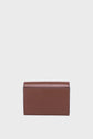 A brown leather wallet, perfect as a petit portefeuille cuir or portefeuille super plat, is displayed upright against a plain light gray background, showing its back side with visible stitching along the edges.