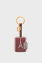 A keychain with a gold ring, a brown strap, and a rectangular red tag featuring the Eiffel Tower, DAREL text, and a blue label marked N°2826—this accessoire Paris exudes un luxe discret while offering a hint of charm DAREL 26 to your everyday essentials.