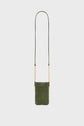 Small green suede crossbody bag crafted from luxurious cuir velours, with black leather corners and a long, thin strap featuring elegant bandoulière chaîne gold accents, displayed against a plain white background.