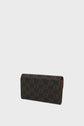 Rectangular clutch purse with a brown and black checkerboard pattern, featuring a repeated logo design reminiscent of the classic portefeuille Gerard Darel style. The purse is photographed against a plain white background.