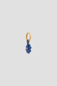 A small gold hoop charm featuring a blue flower-shaped pendant with a gold center, set against a plain light gray background—perfect as an élégant porte-bonheur or to add a unique touch to your accessoires de sac.