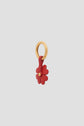 A gold circular keyring holding a red leather flower-shaped charm en cuir with visible petal details, displayed on a plain light gray background. This bijou luxe accessory adds an elegant touch, making it a perfect porte-bonheur for everyday style.