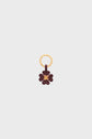 Gold keyring with a brown, flower-shaped charm cuir featuring a small gold button at the center—this elegant bijou clé is displayed on a plain light gray background.