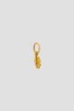 A small gold charm shaped like a daisy flower with a circular loop at the top for attaching to a bracelet or necklace, this porte-bonheur is displayed against a plain light gray background.
