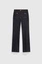 A pair of dark blue denim noir chiné jeans displayed flat on a white background, featuring wide legs, two grandes poches à boutons dorés at the back with button flaps, and visible brown stitching.