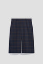 Navy blue and dark brown plaid tailored shorts with belt loops and side pockets, displayed against a plain light grey background, offer a chic nod to the style preppy aesthetic. Perfect as a bermuda mi-long femme option, these shorts blend comfort and sophistication effortlessly.